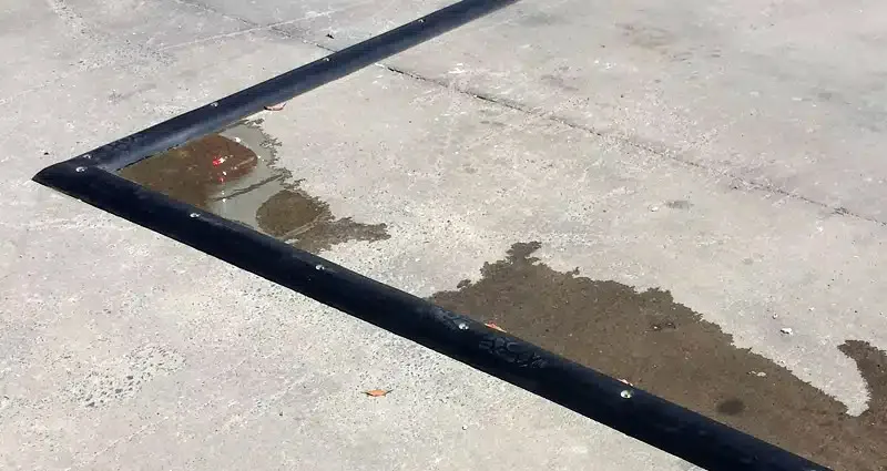 Black rubber floor bunding installed outdoors