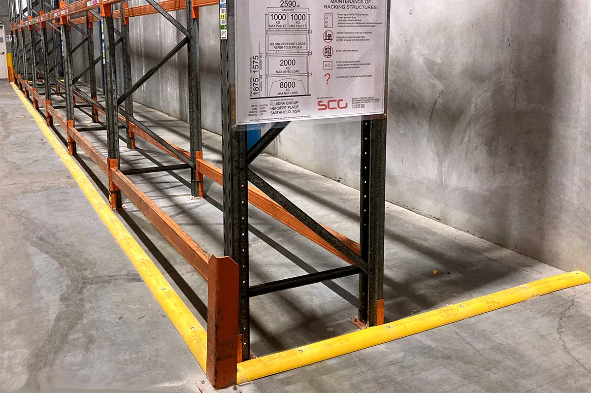 Safety yellow rubber floor bunding installed around warehouse racking